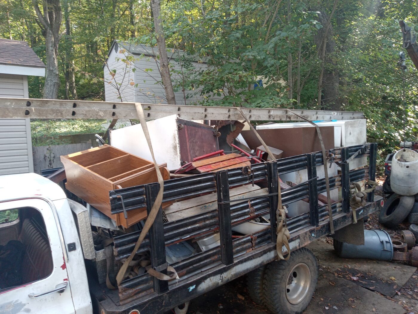 Closer view of a dresser and chair loaded on the flatbed over scrap steel