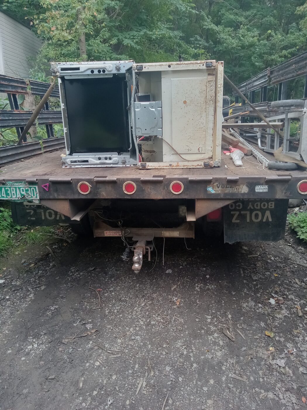 Close view of the flatbed tailgate loaded with an oven door and cabinet panel