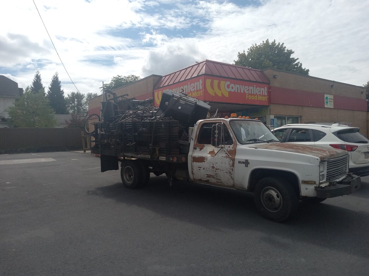 Closer view of the loaded scrap truck at the gas station